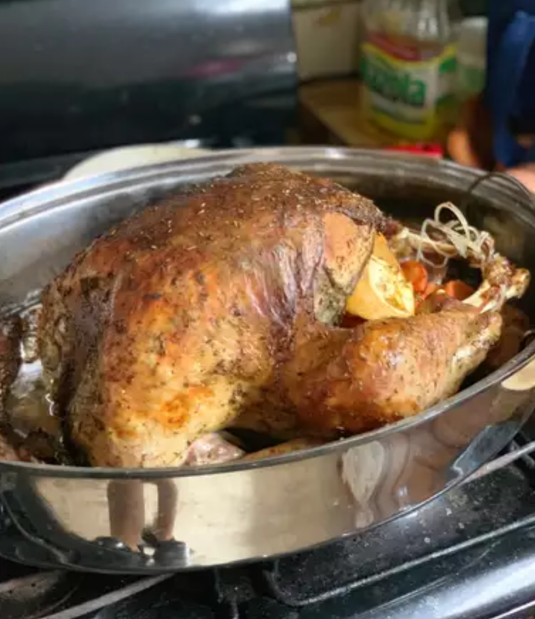 Butter-Blanketed Turkey roasted to golden perfection in a stainless steel pan, ideal for a holiday feast.